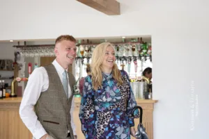 Natural documentary style photograph of the groom meeting the wedding guests at his Blithfield Lakeside Barns Wedding.