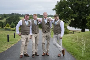 The groom and the groomsmen relaxed professional photographs on the drive up to Staffordshire wedding venue Blithfield Lakeside Barns.