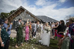 Beautiful confetti shot of the bride and groom after their Blithfield Lakeside Barns wedding ceremony.