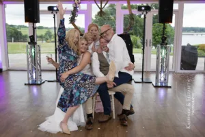 The professional wedding photographer and DJ tag team to capture epic shots of the bride and groom and their guests.